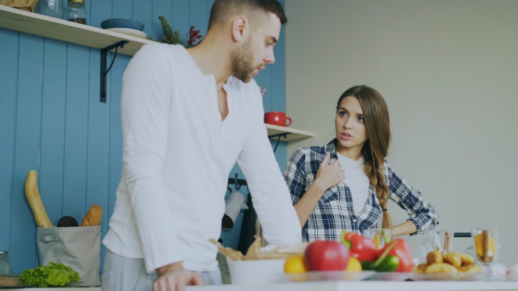 "Couple in tense conversation at home"