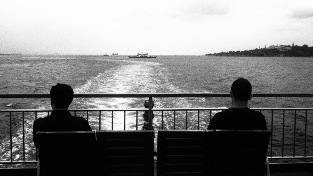 "Couple on bench by water"
