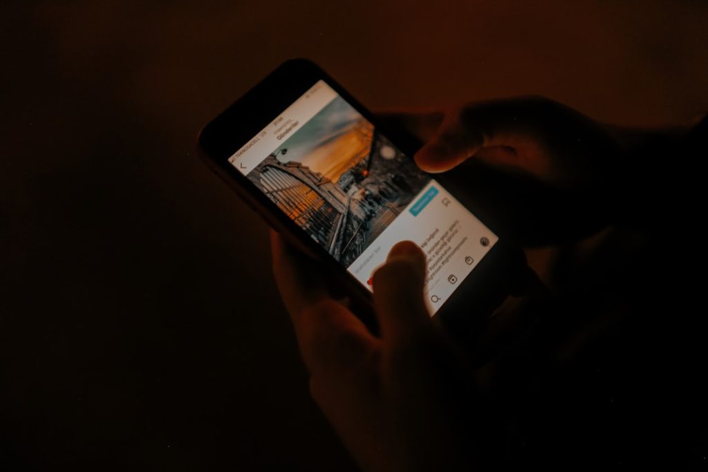 a person holding a cell phone in their hand