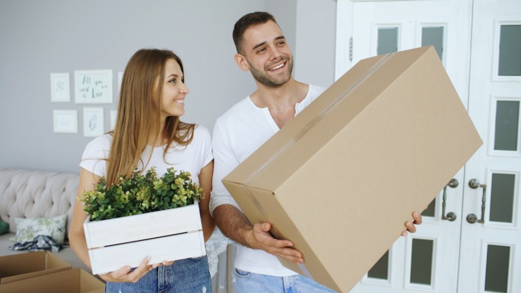 Couple talking while moving into a home