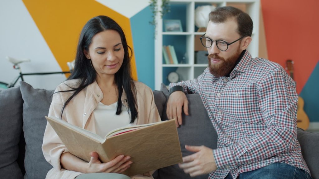 Couple looking at an open photo album together