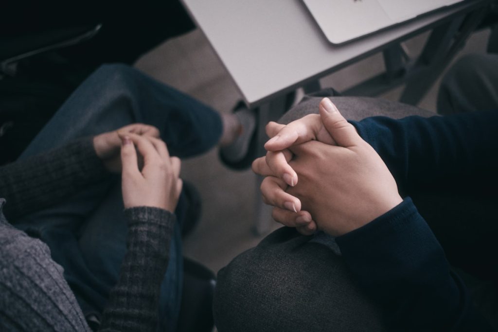 "Two people holding hands reconciliation"