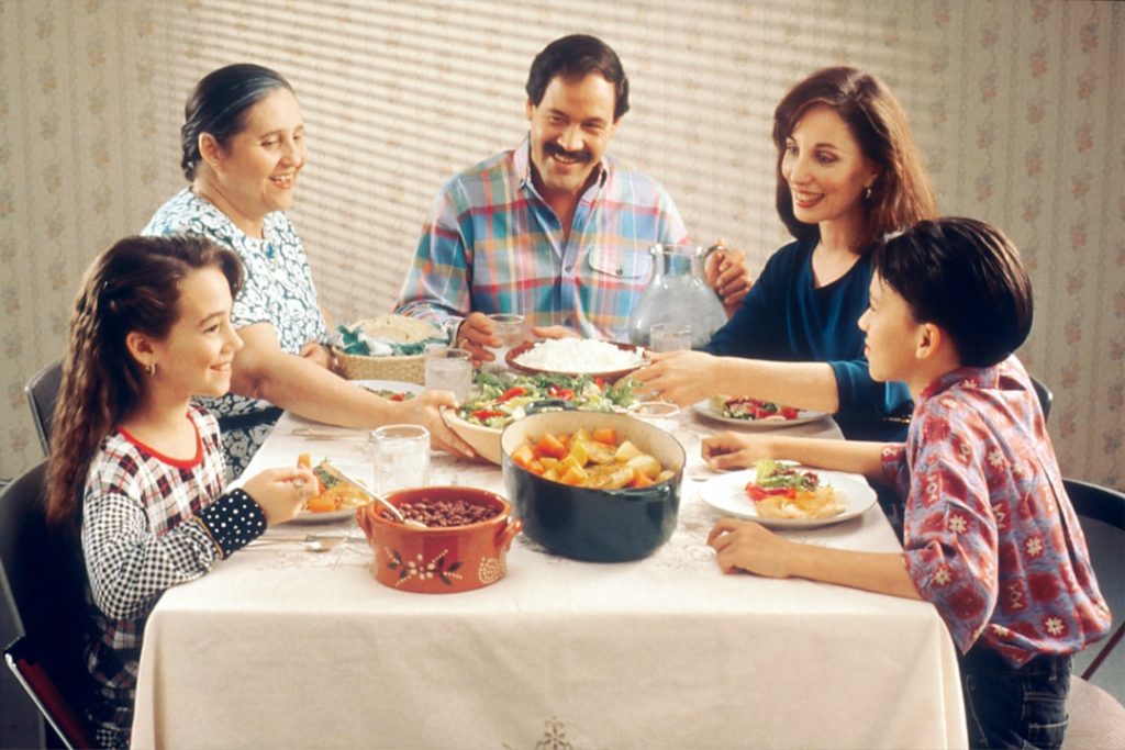 A tense family dinner table after an argument