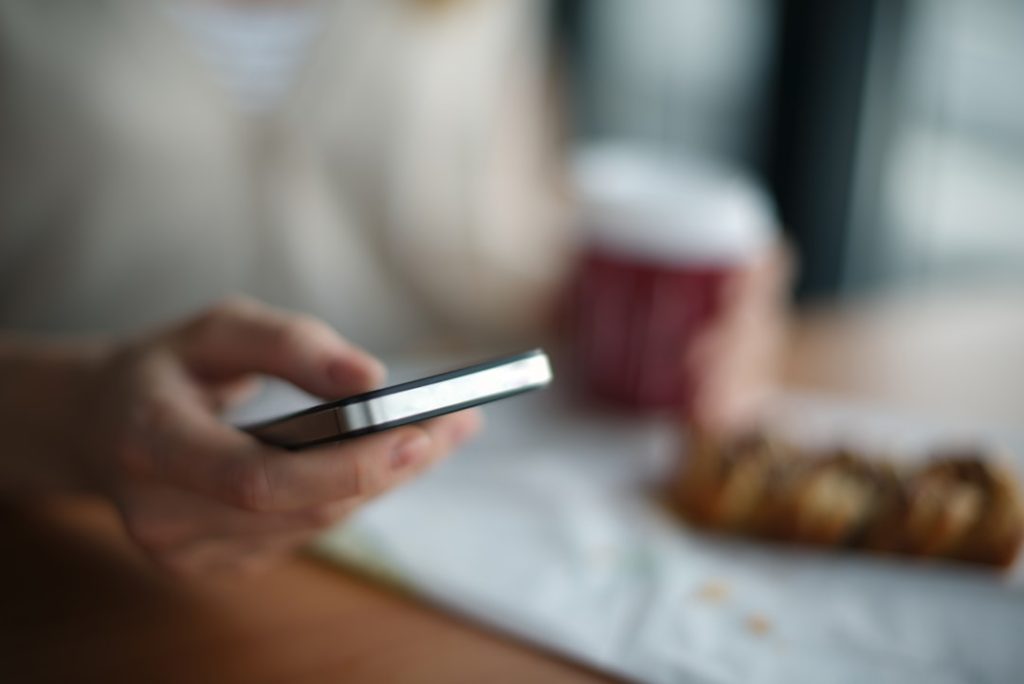 Person holding a phone while reading a text message