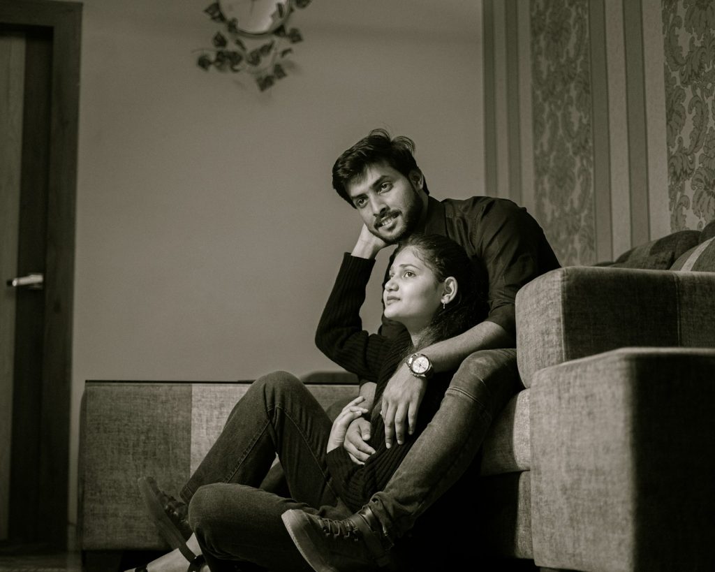 A man and a woman sitting on a couch